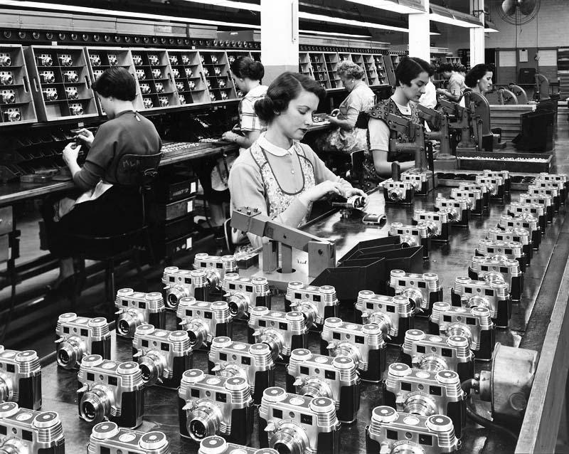 Women carefully assembled cameras in a fast-paced environment. Precision was vital, but the monotonous work often led to strain injuries and exhaustion.